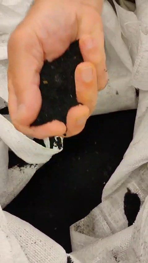 Composite crumb feedstock held in hand